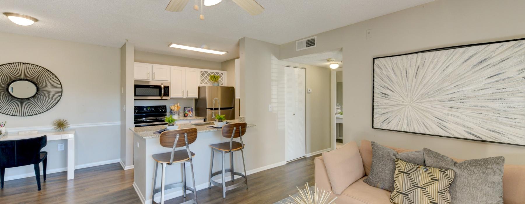a living room with a kitchen and a dining table