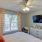 a bedroom with a large bed and a television