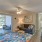 a living room with a blue rug