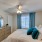 a bedroom with a bed and a fan