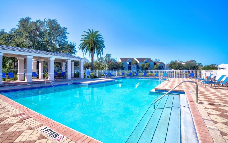 a swimming pool with a building in the background