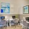 a room with a desk and chairs