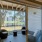 a room with a window and a patio with a table and chairs