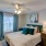 a bedroom with a bed and a fan