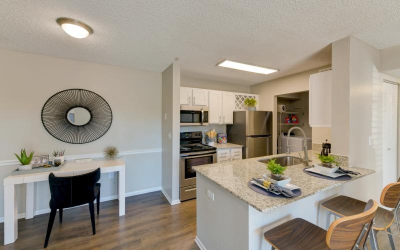 a kitchen with a table and chairs