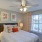 a bedroom with a fan and a bed