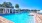 a swimming pool with a building in the background